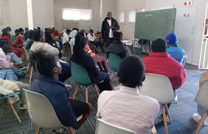 SSF facilitator leading a small group discussion in a community hall