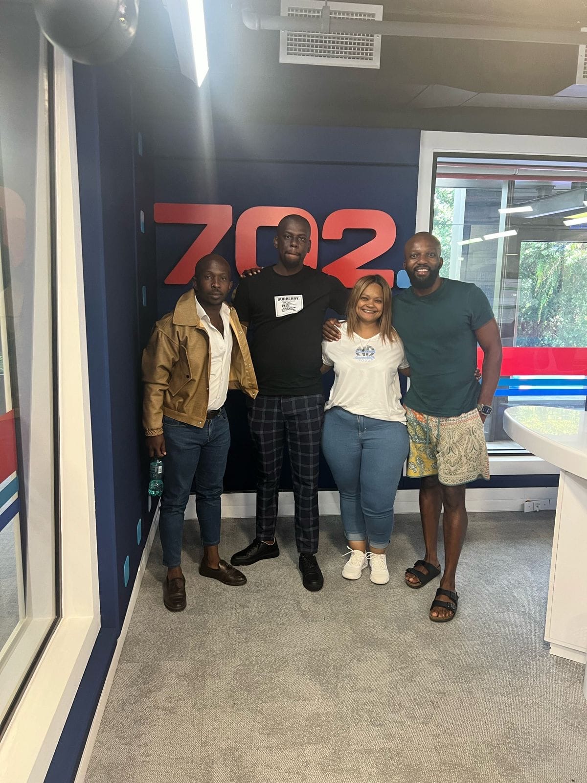 SSF team members standing in front of the 702 studio wall